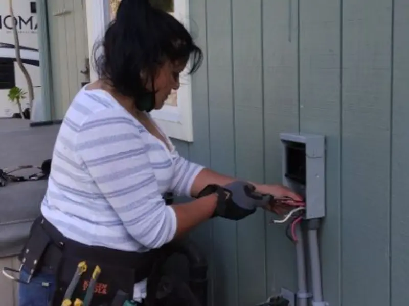 Licensed electrician wiring an exterior subpanel in Maybrook